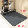 Black square absorbent drain pad mat with PU leather surface on a kitchen countertop