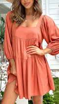 Orange children's pullover dress with square collar, puff sleeves, and backless A-line design.