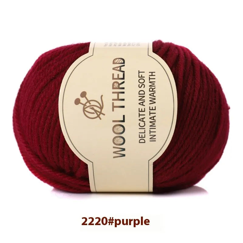 One roll of beige domestic wool hand-knitting yarn for size 10 needles next to knitting needles.