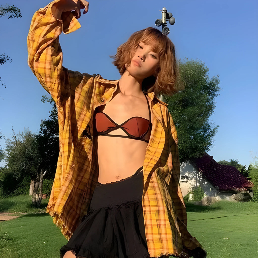 Loose-fit yellow plaid cardigan-style shirt for men and women on a hanger