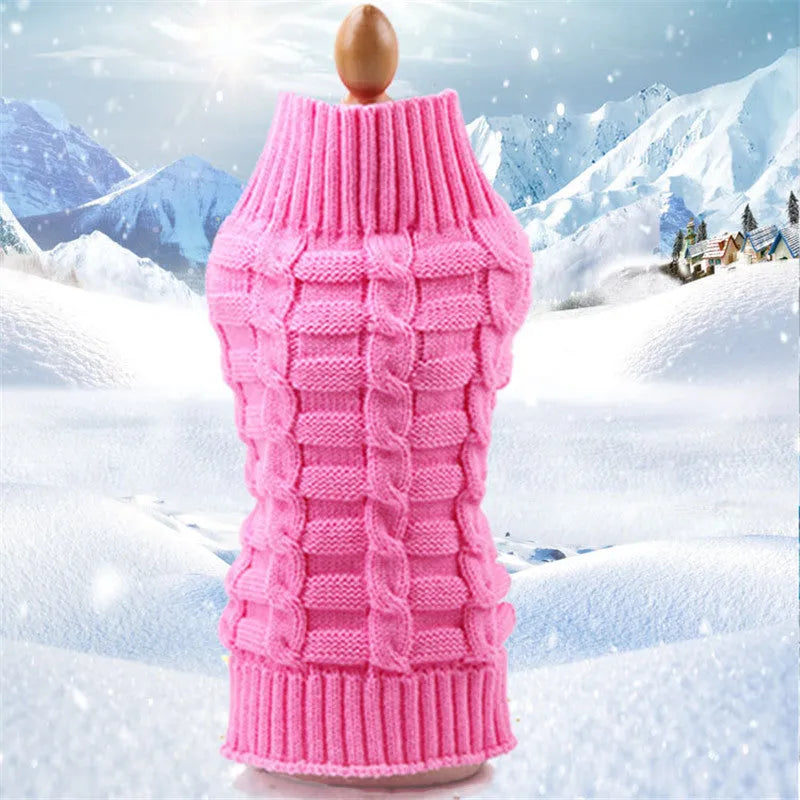A blue cashmere wool dog sweater with a twisted rope design laid flat, showing its size and shape.