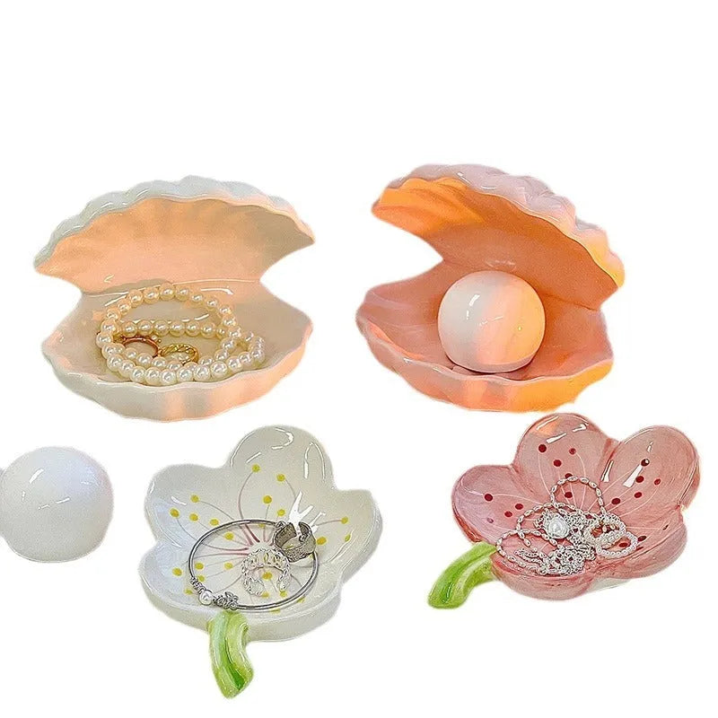 White porcelain shallow tray with a matching shell-shaped night light unit inside, on a wooden surface.