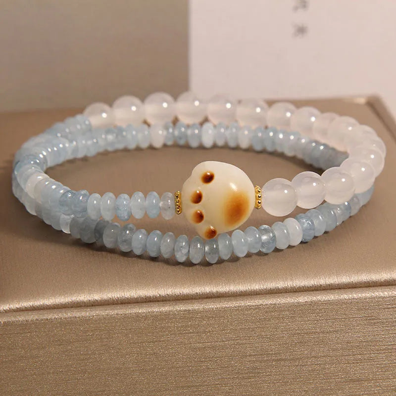 Women's crystal bracelet with aquamarine abacus beads, white agate, and cat's paw accents in double ring design