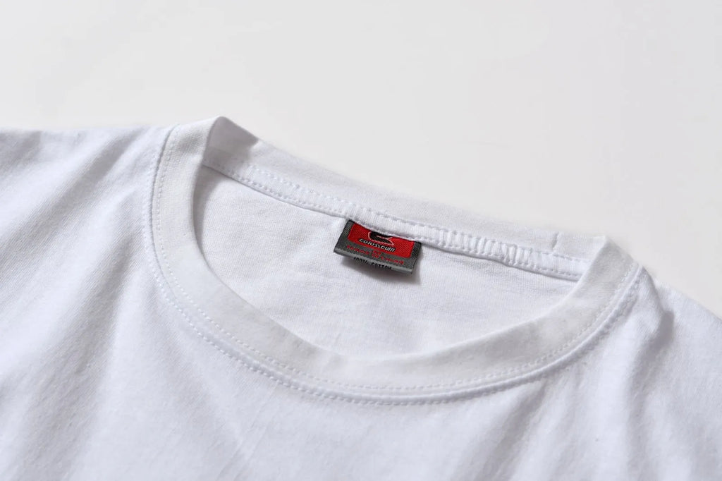 White cotton T-shirt overalls with a round neck and short sleeves, shown in a loose pullover style.