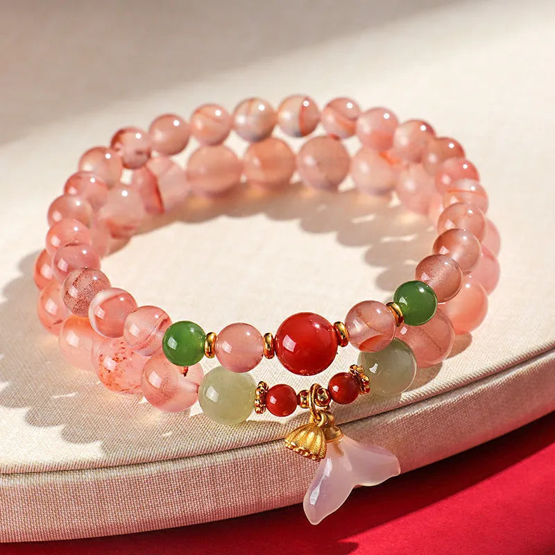 Women's ice floating south red white agate fishtail bracelet showing natural stone colour variation and textured design