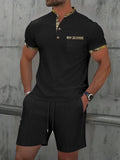 Men's grey zip-up polo collar short sleeve top and shorts tracksuit set laid flat.