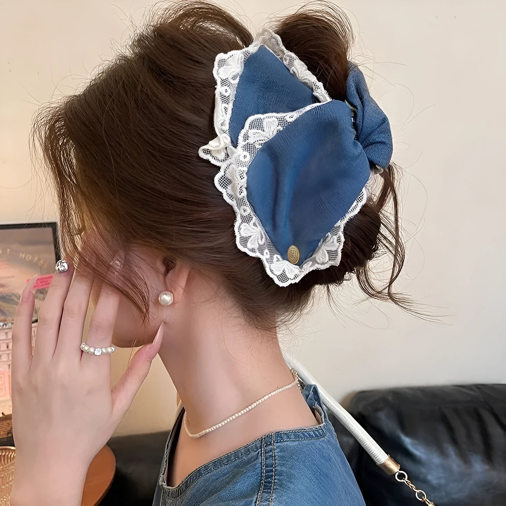 Women's denim bow hair clip with triangle grip, handmade from fabric and acrylic.