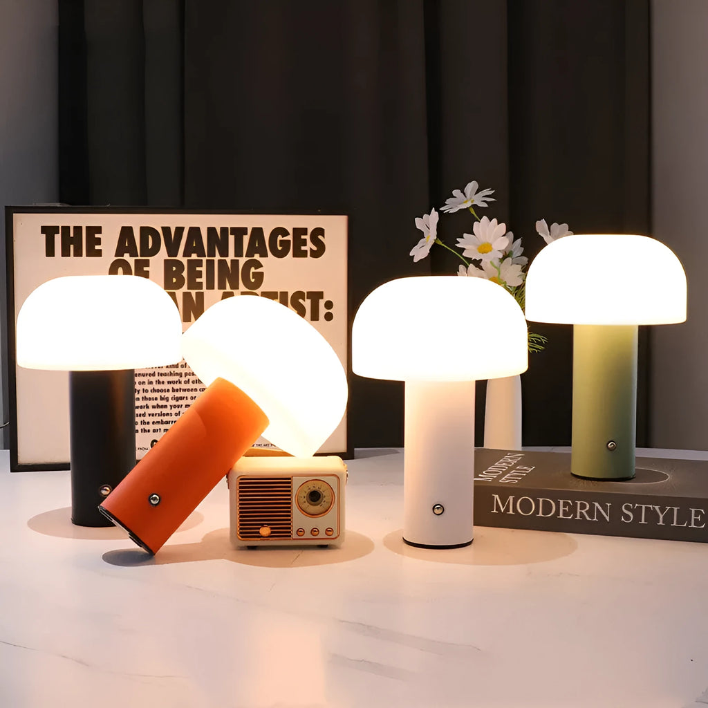 White plastic USB table lamp with integrated charging port on a wooden desk.