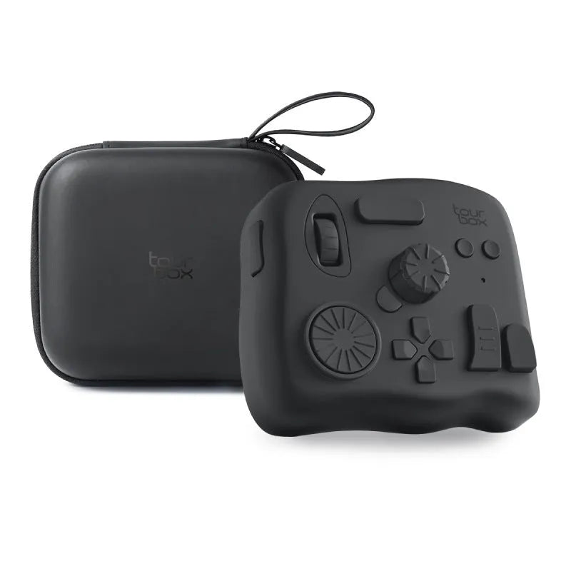 TourBox NEO black video editing controller with dials and buttons on a desk next to a tablet.