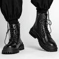 Men's black mid-top waterproof boots with a rubber sole on a grey background.