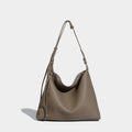 Large caramel coloured PU messenger bag with shoulder strap showing 36cm length