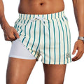 Men's loose green boxer-style swimming trunks made from elastic spandex fabric.