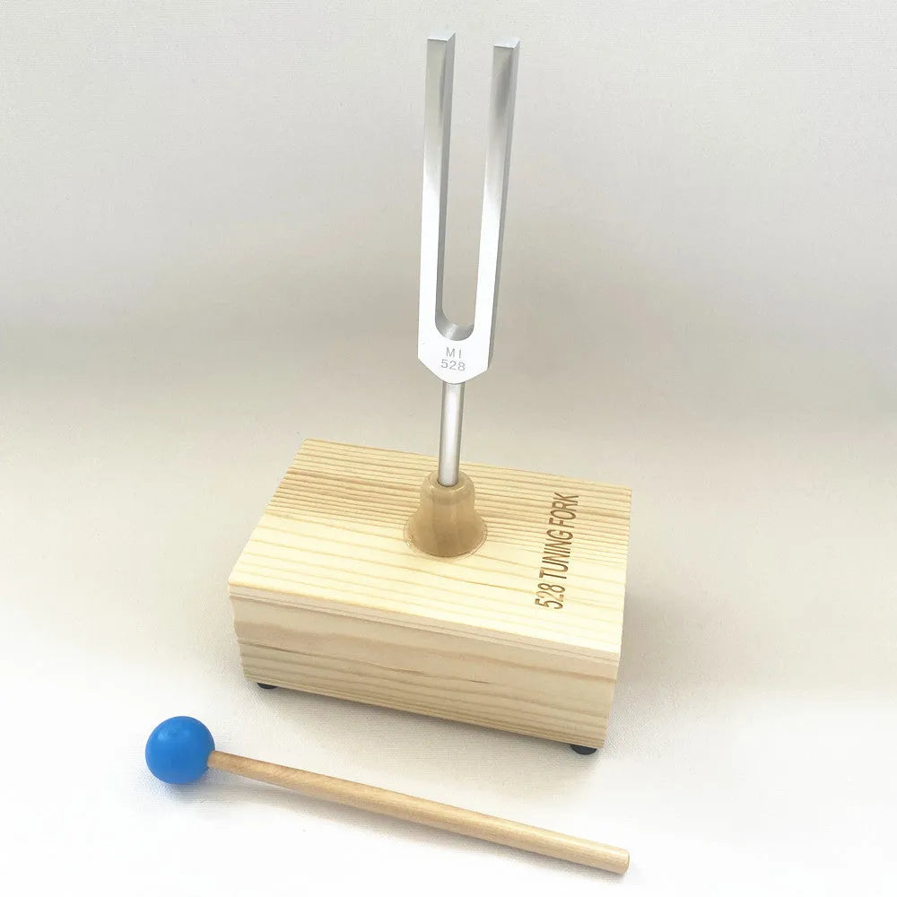 Aluminium alloy 432Hz tuning fork and speaker set on a kraft paper box.