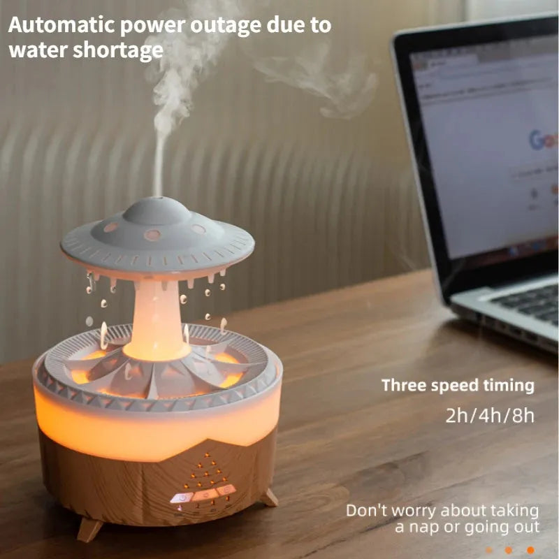UFO cloud-shaped humidifier with LED lights and water droplet effects on dark surface