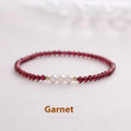 Adjustable women's bracelet with garnet and artificial pearl beads on wrist