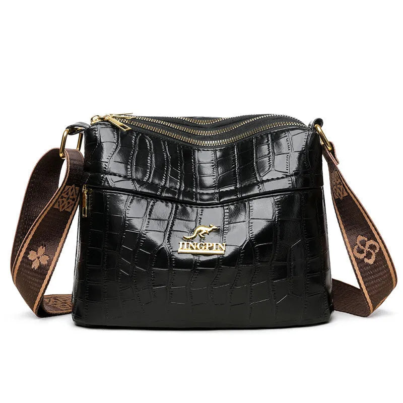 Brown cross body messenger bag with multiple compartments and sewing thread details on PU material
