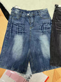 Man wearing loose-fit light blue washed denim shorts with a straight leg and cropped length.