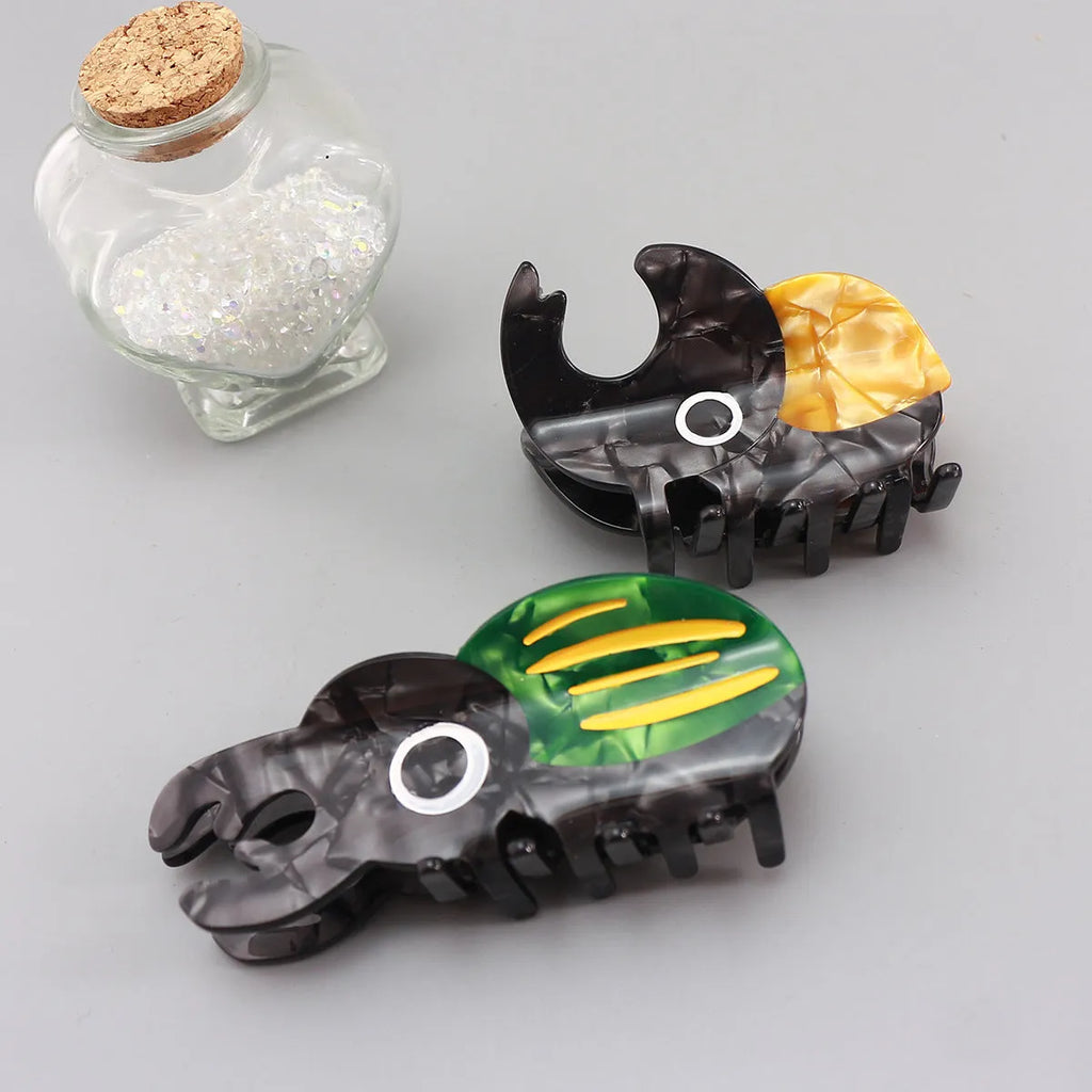 Handmade cellulose acetate beetle grip hair accessory with cartoon insect design