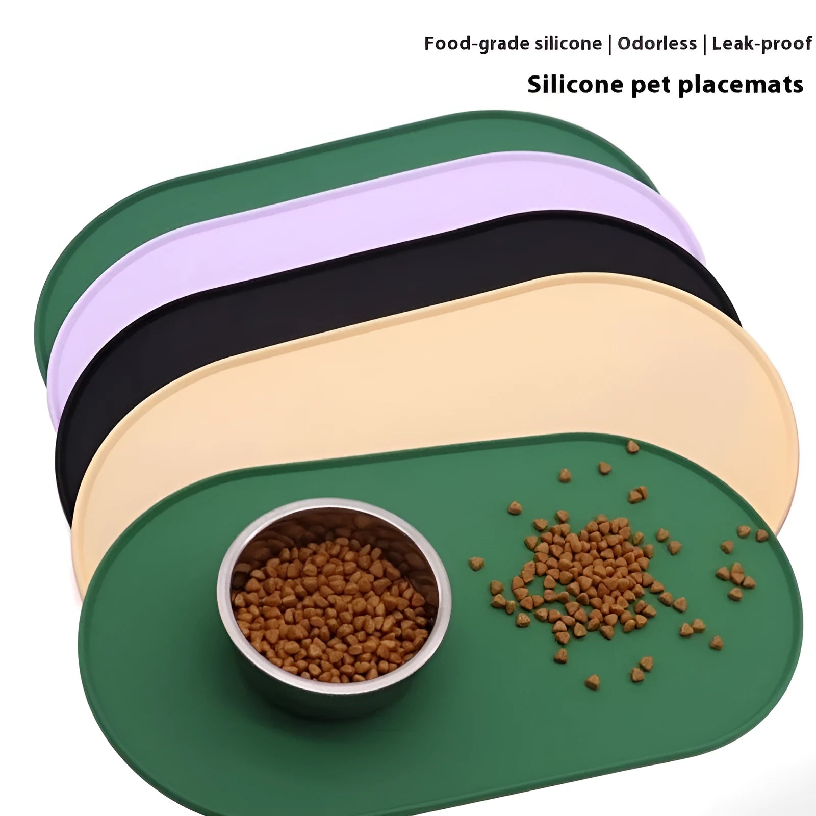 Green silicone cat feeding mat with raised edge holding a food bowl and water bowl on a kitchen floor.