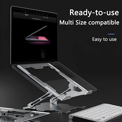Grey aluminium folding laptop stand shown at an adjustable angle on a wooden desk.