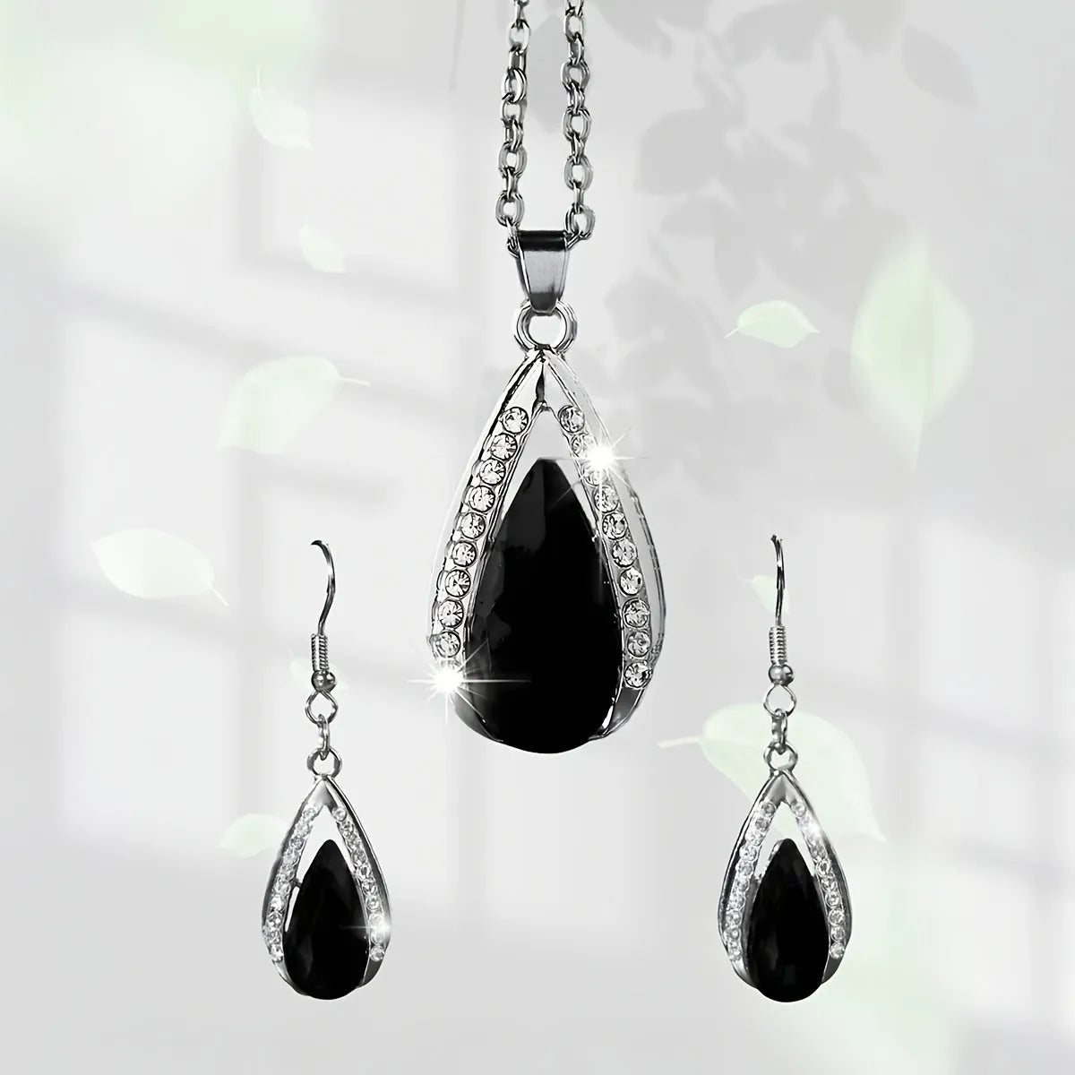 Black and red teardrop-shaped glass pendant necklace and matching earrings set on alloy chain.