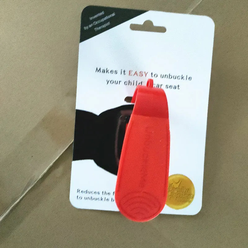 Red ABS coated car seat buckle unlocker measuring 4 x 9 cm on a keyring