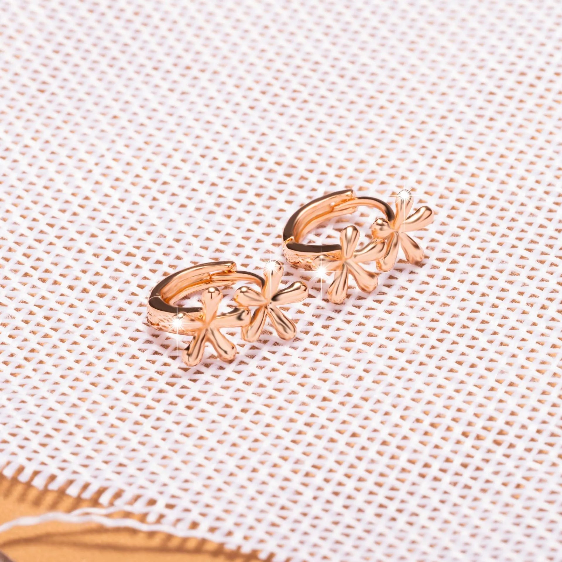 Rose gold electroplated waterdrop flower earrings with circular 20mm floral design on a white background.