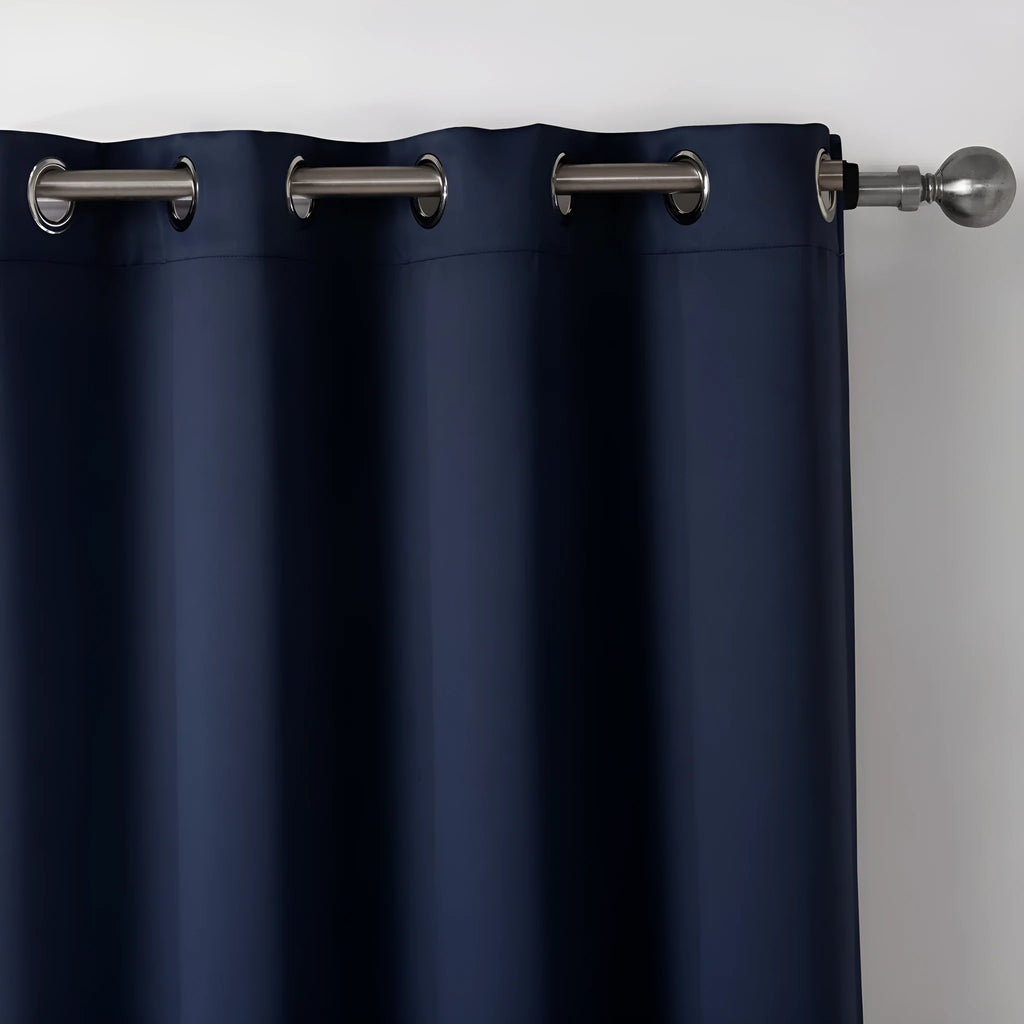 Dark navy blue blackout curtain hanging, showing its modern simple style and light-blocking fabric.