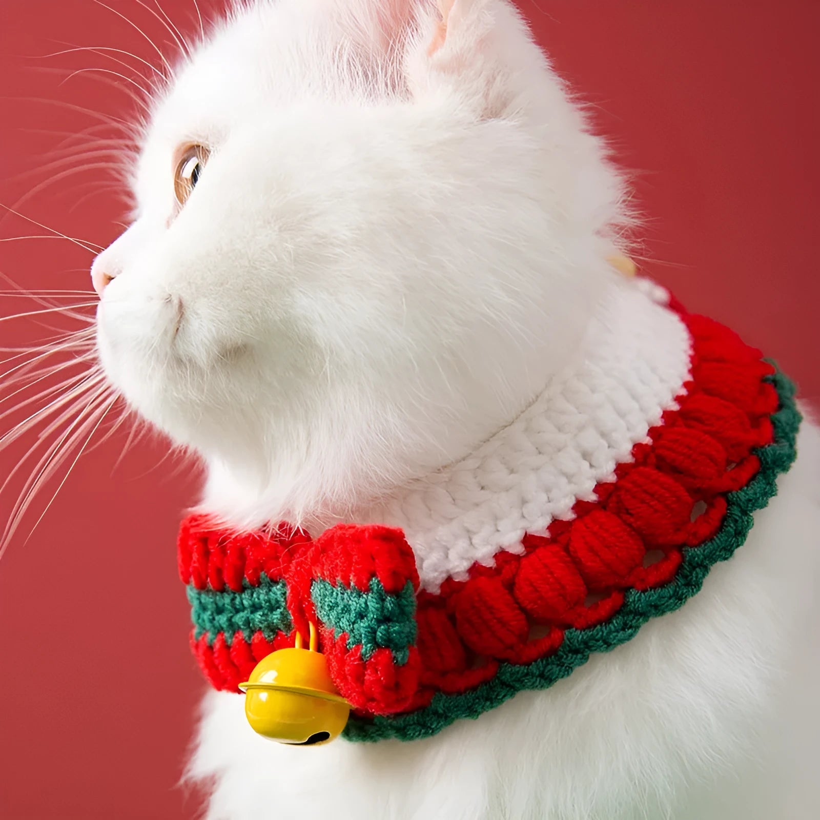 Hand-knitted Christmas cat collar in milk cotton yarn with festive bow design