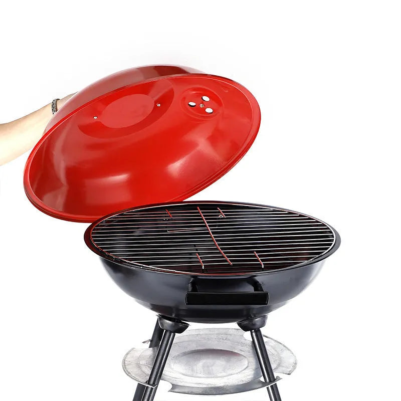 A portable 14-inch diameter iron barbecue grill with an Apple Stove design, shown on a garden patio.