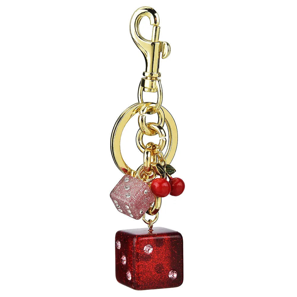 Square cherry red and silver two-tone dice keychain pendant with metal keyring on a grey background