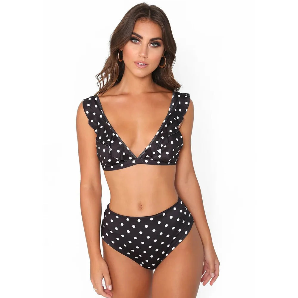 Women's black and white polka dot bikini set with ruffled deep V-neck top and matching shorts