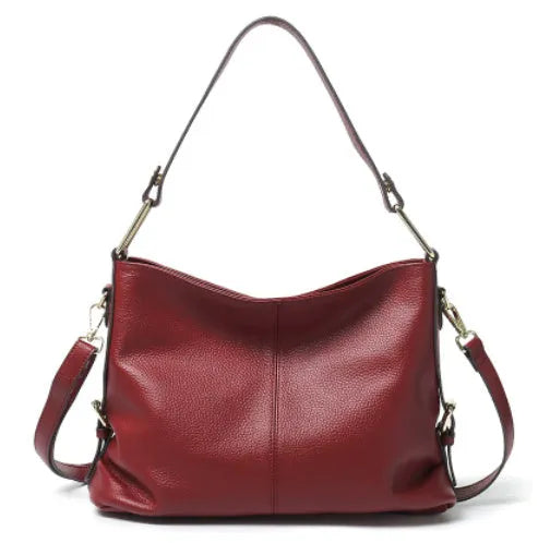Genuine leather vertical square crossbody bag in black with sewing line detail and external pocket.