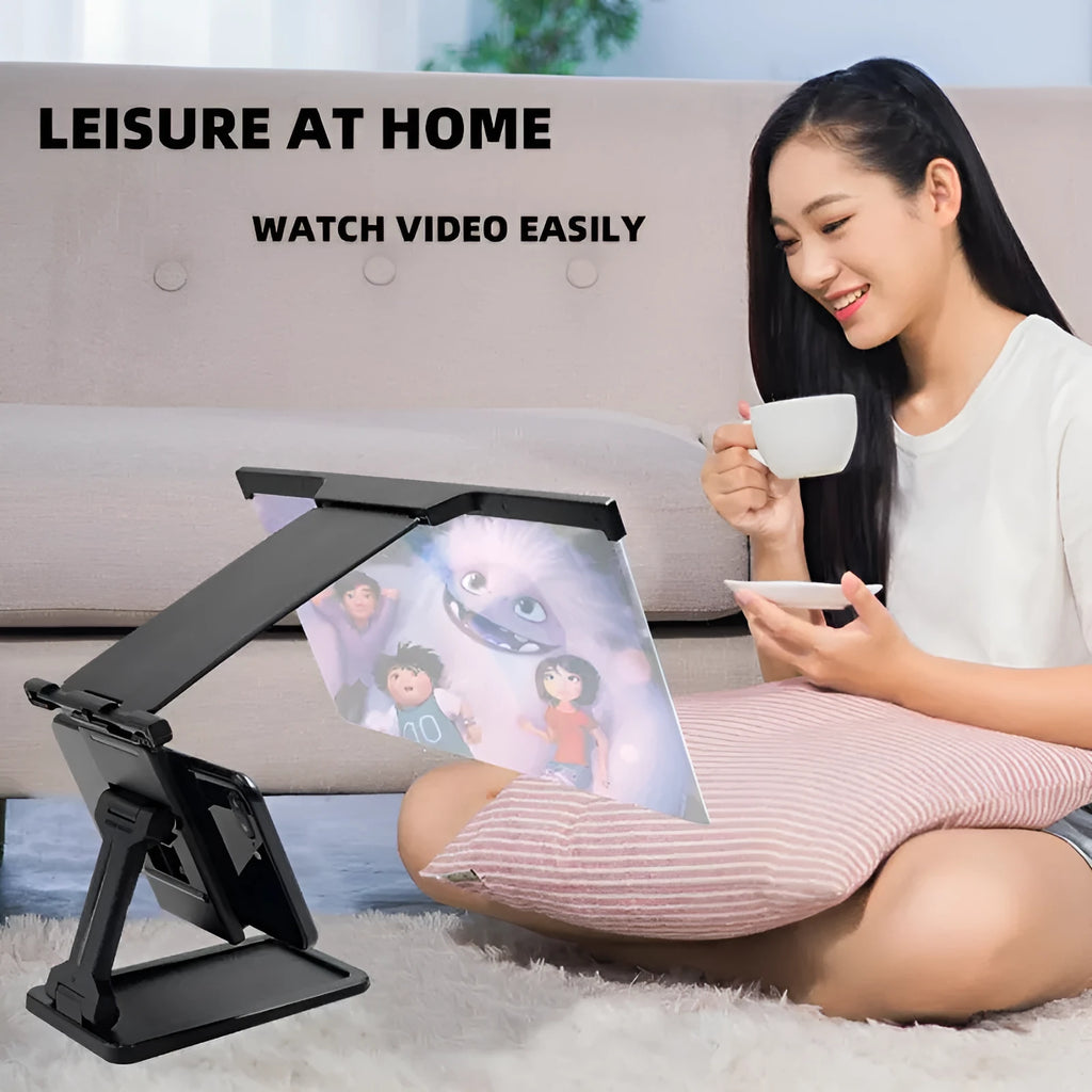 Black foldable mobile phone screen magnifier with detachable shading holder on a desktop.