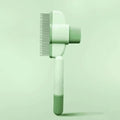 Green and yellow dog grooming brush with silicone bristles and one-click hair removal mechanism