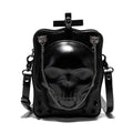 Black mini square crossbody bag with embossed skull design, metal chain strap, and zip closure.