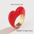 Colourful three-dimensional heart-shaped enamel ring in zinc alloy on a hand.