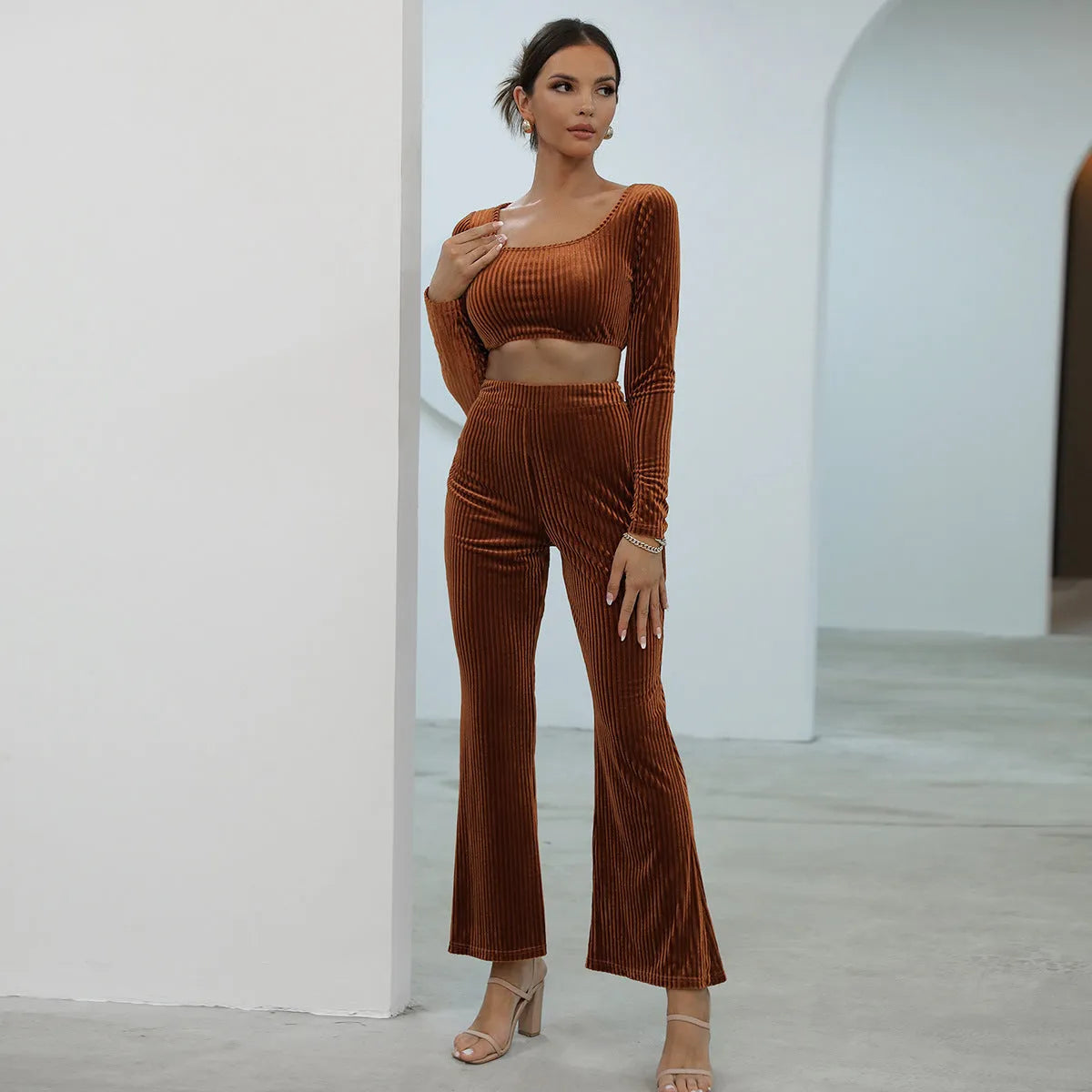 Caramel coloured long sleeve sweater and trouser set laid flat, showing casual two-piece design.