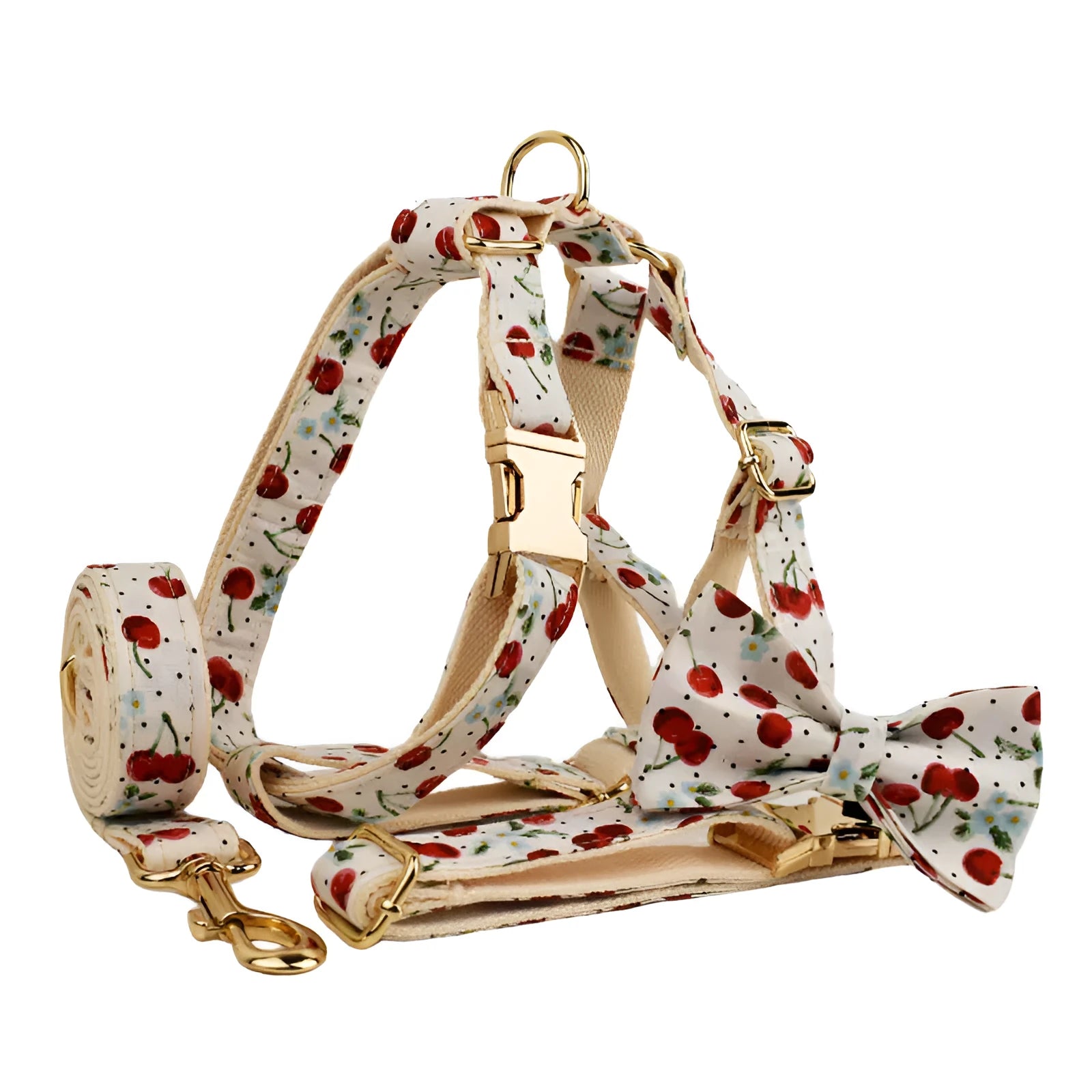 Red cherry print pet collar, lead, and harness set with light gold buckles and matching waste bag dispenser