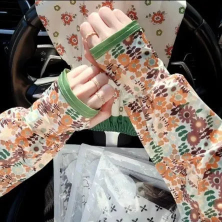 A pair of ice silk fabric oversleeves with a floral print design, shown laid flat.