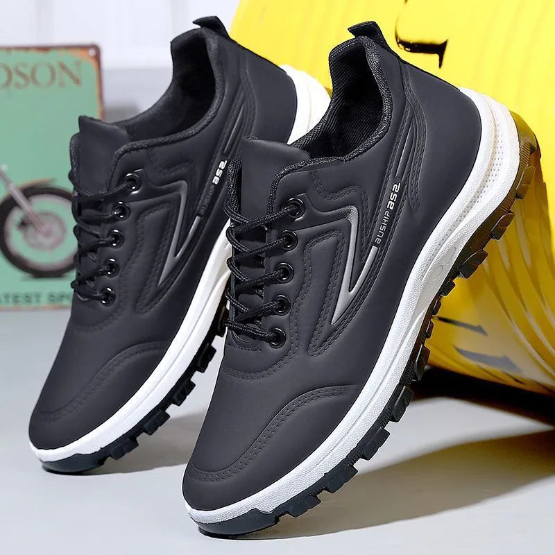 Men's black and grey waterproof PU casual shoes with a pointed toe and flat plastic sole on a white background.