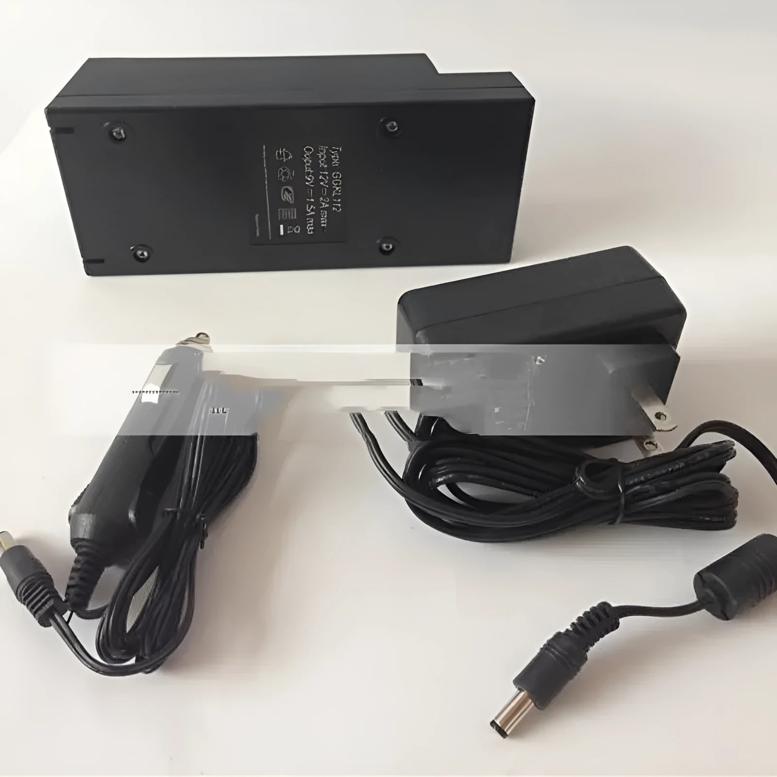 GKL112 compact white 220V car charger with UK plug on a car dashboard