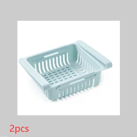 Blue telescopic plastic storage basket for refrigerator organisation with fruits and vegetables inside.