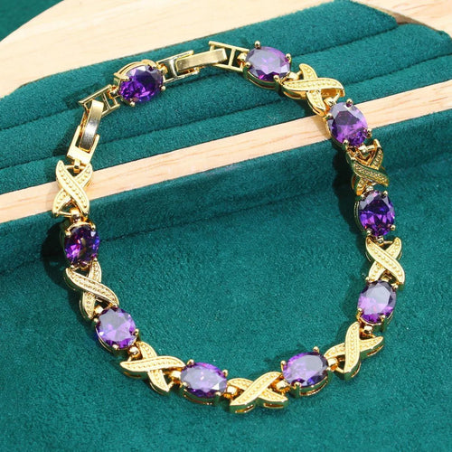 18k gold-plated necklace, earrings, ring, and bracelet set with colourful Raytheon-cut cubic zirconia stones.
