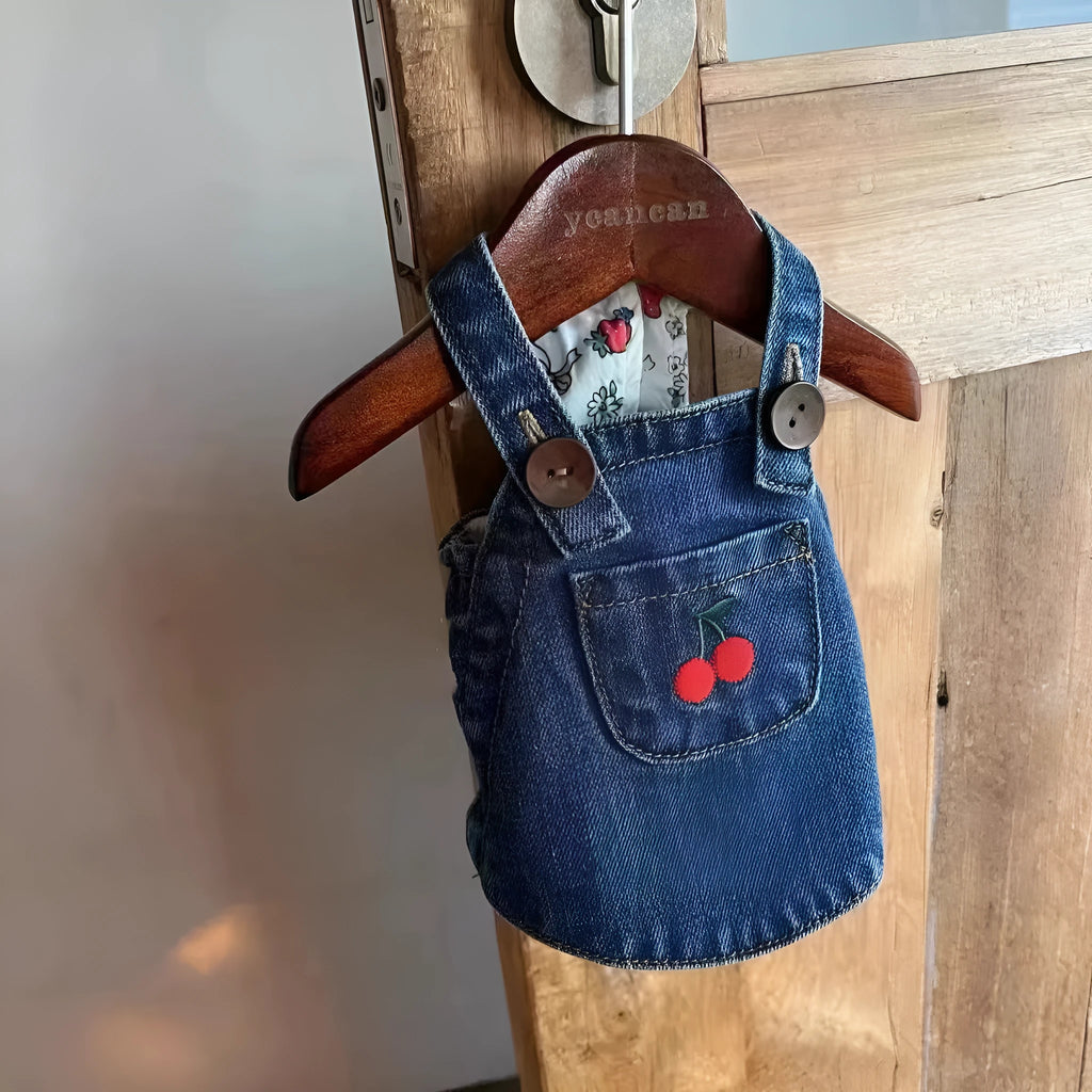Small dog wearing a cherry dark blue denim skirt for spring summer