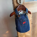 Small dog wearing a cherry dark blue denim skirt for spring summer