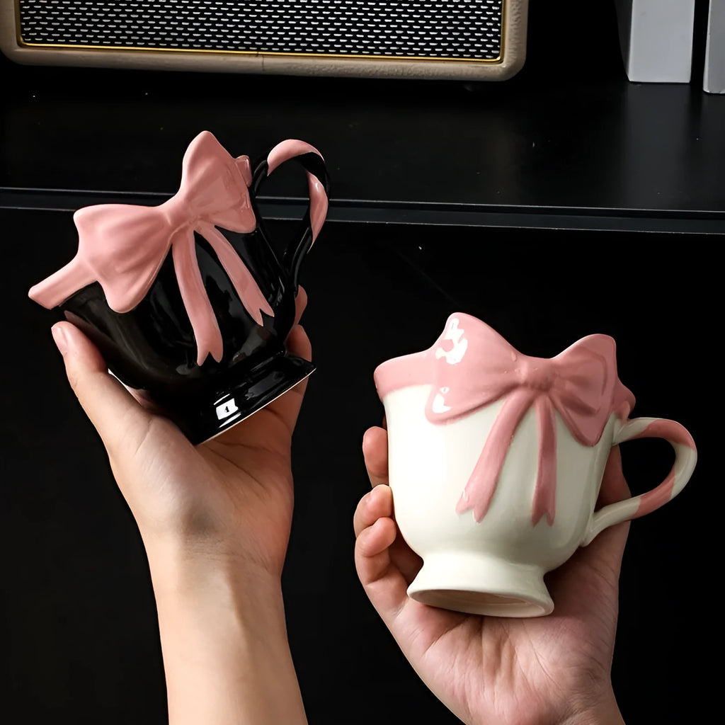Ceramic mug with heart bow design in black pink and white powder colour options