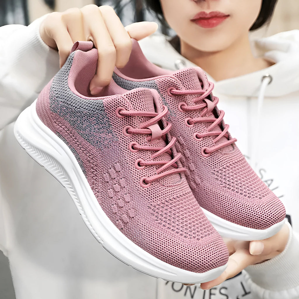 Women's low-top lace-up sneakers in black mesh with a round toe and soft PVC sole.