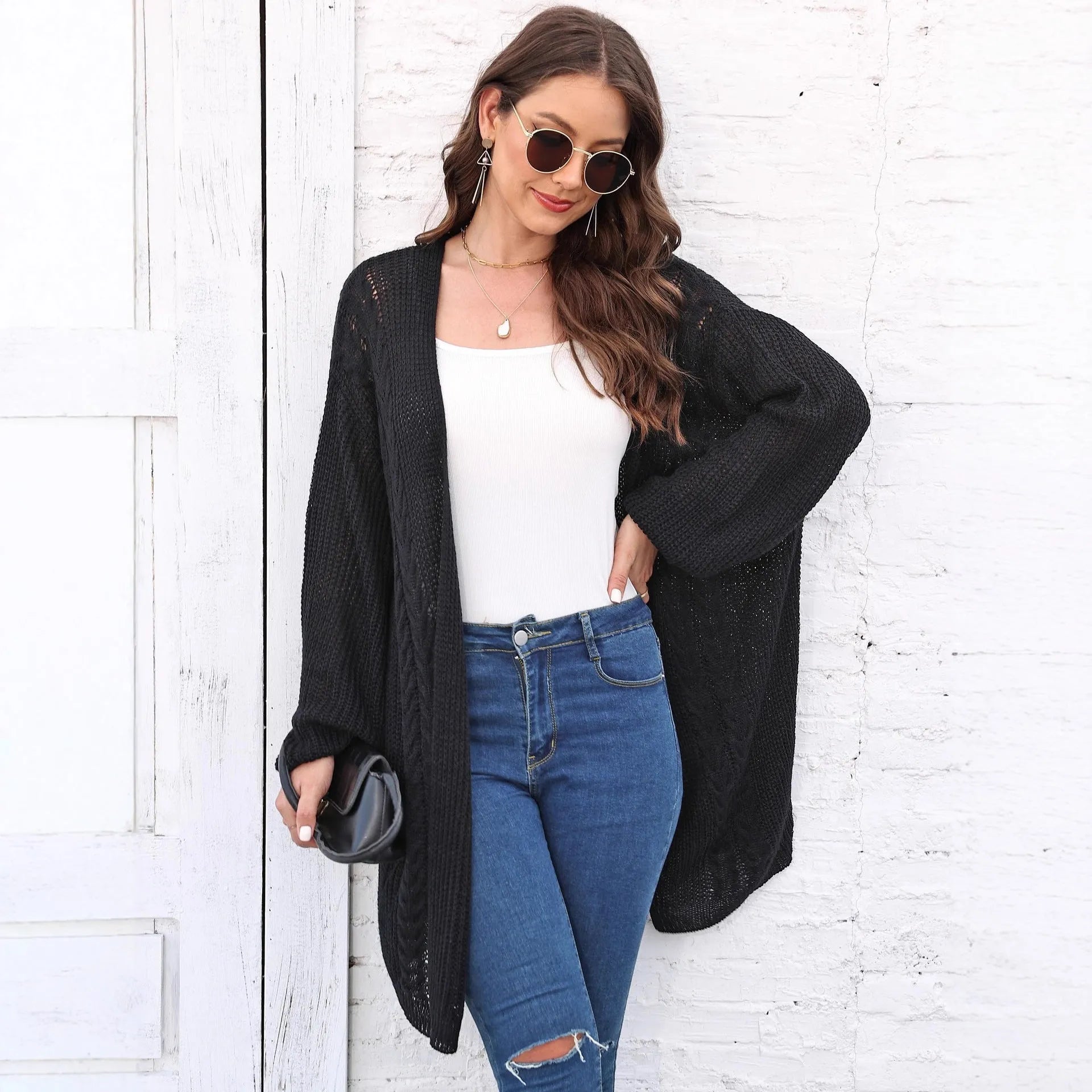 Brown loose-fitting acrylic sweater coat for women on a hanger.