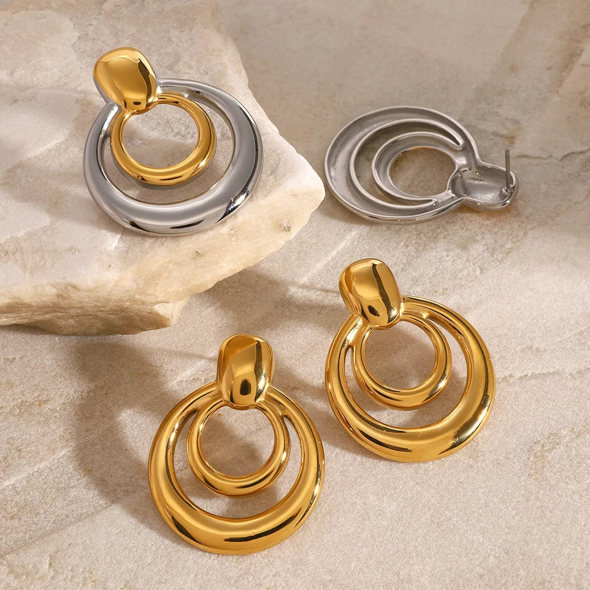 Round double layer hollow stud earrings with 18K gold electroplated finish on titanium steel
